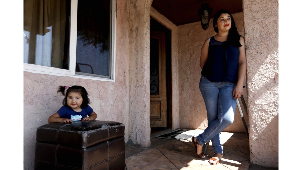 Adela Jimenez, 38, mother of six children, shown with daughter Esmeralda Jimenez, 20-months, had contaminants removed from the soil surrounding her home in February.