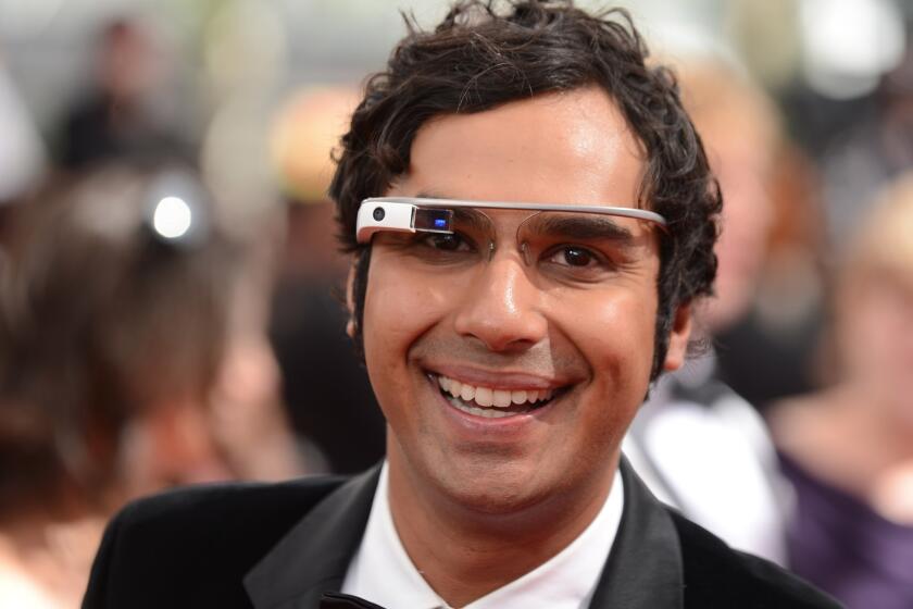 Kunal Nayyar, wearing Google Glass, arrives Sunday at the 65th Primetime Emmy Awards at Nokia Theatre in Los Angeles.