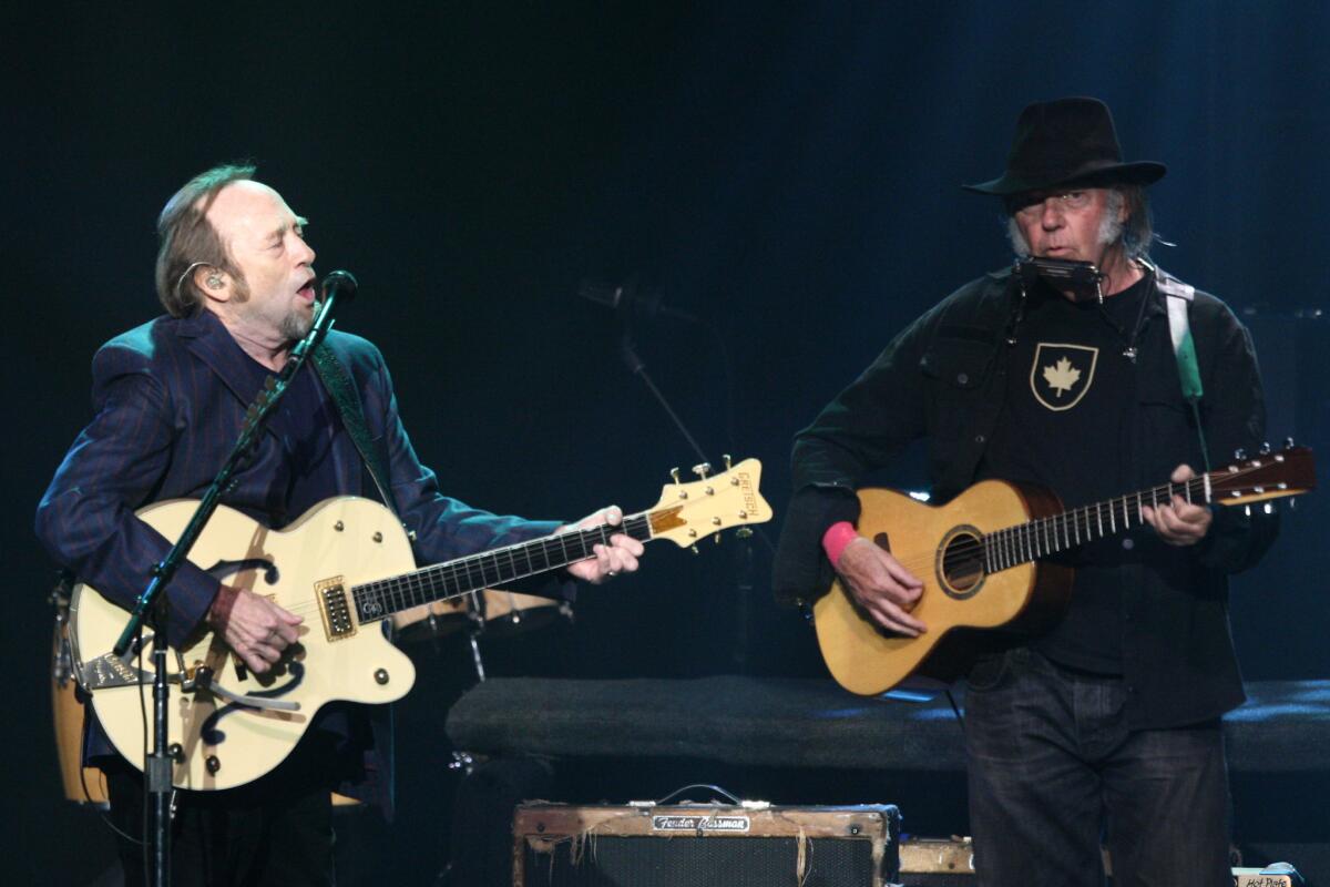 Stephen Stills, left, and Neil Young perform during the third Light Up the Blues Concert to benefit Autism Speaks on Saturday night at the Pantages Theatre in Hollywood.