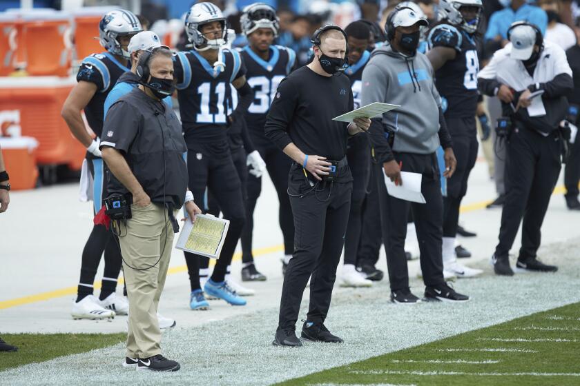 Carolina Panthers offensive coordinator Joe Brady watches from the sideline during an NFL football game against the Detroit Lions, Sunday, Nov. 22, 2020, in Charlotte, N.C. (AP Photo/Brian Westerholt)