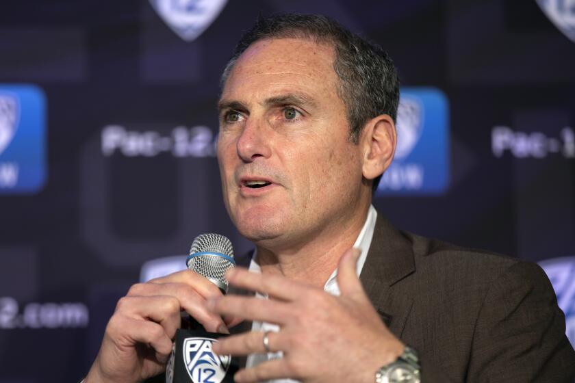 Pac-12 Commissioner Larry Scott speaks to reporters 