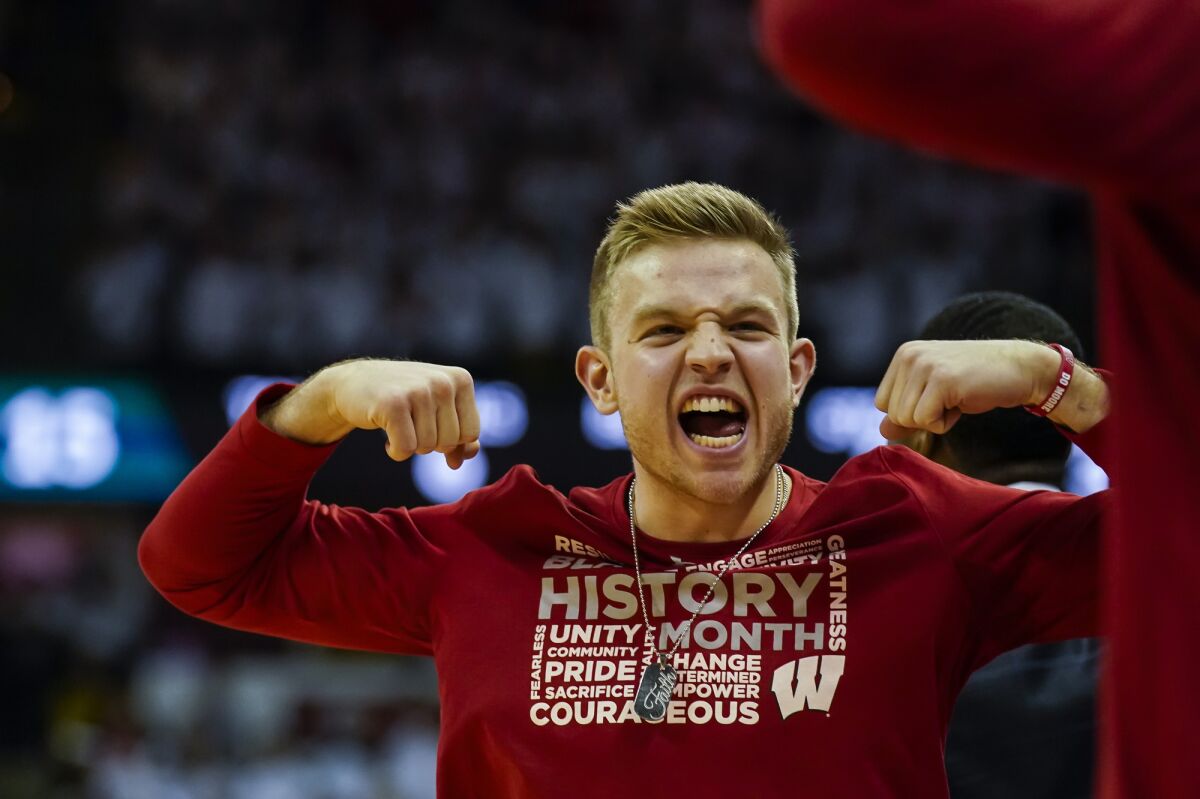 Wisconsin's Brad Davison celebrates after a teammate was fouled by Michigan State player during the first half of an NCAA college basketball game Saturday, Feb. 1, 2020, in Madison, Wis. Davison is serving a one-game suspension. (AP Photo/Andy Manis)