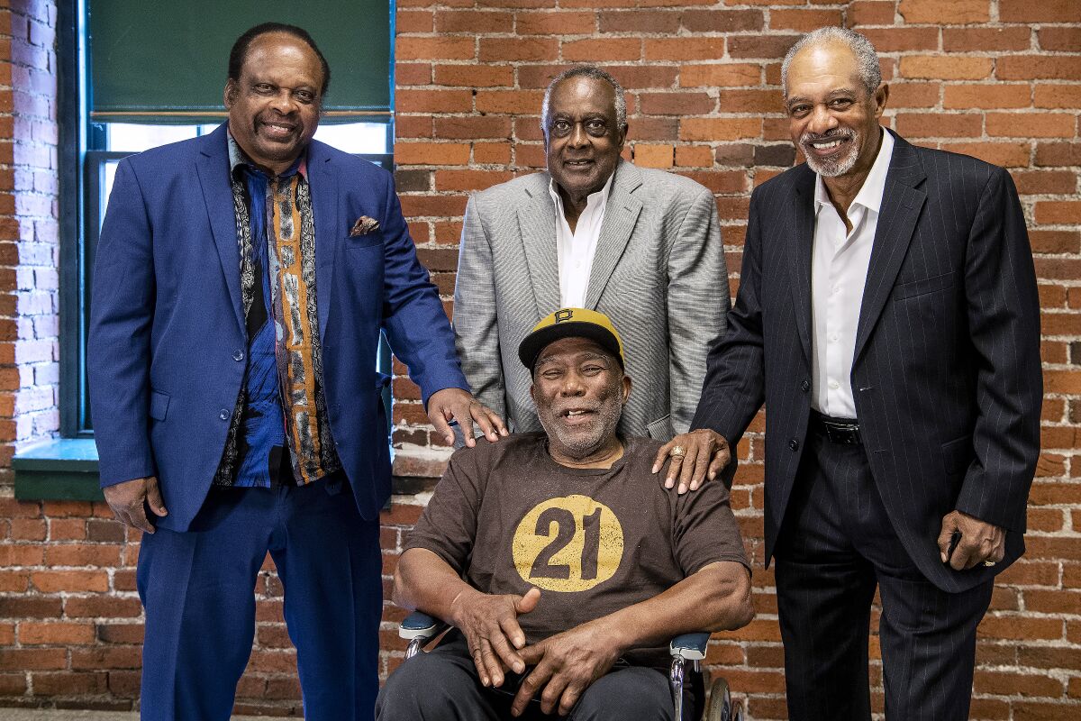 Al Oliver, Gene Clines, Manny Sanguillen, seated, and Dave Cash pose for a portrait during an event hosted by the Pittsburgh Pirates to celebrate the 50th anniversary of the first all-minority lineup to take the field in Major League Baseball history, at the Heinz History Center, Wednesday, Sept. 1, 2021, in Pittsburgh. (Alexandra Wimley/Pittsburgh Post-Gazette via AP)