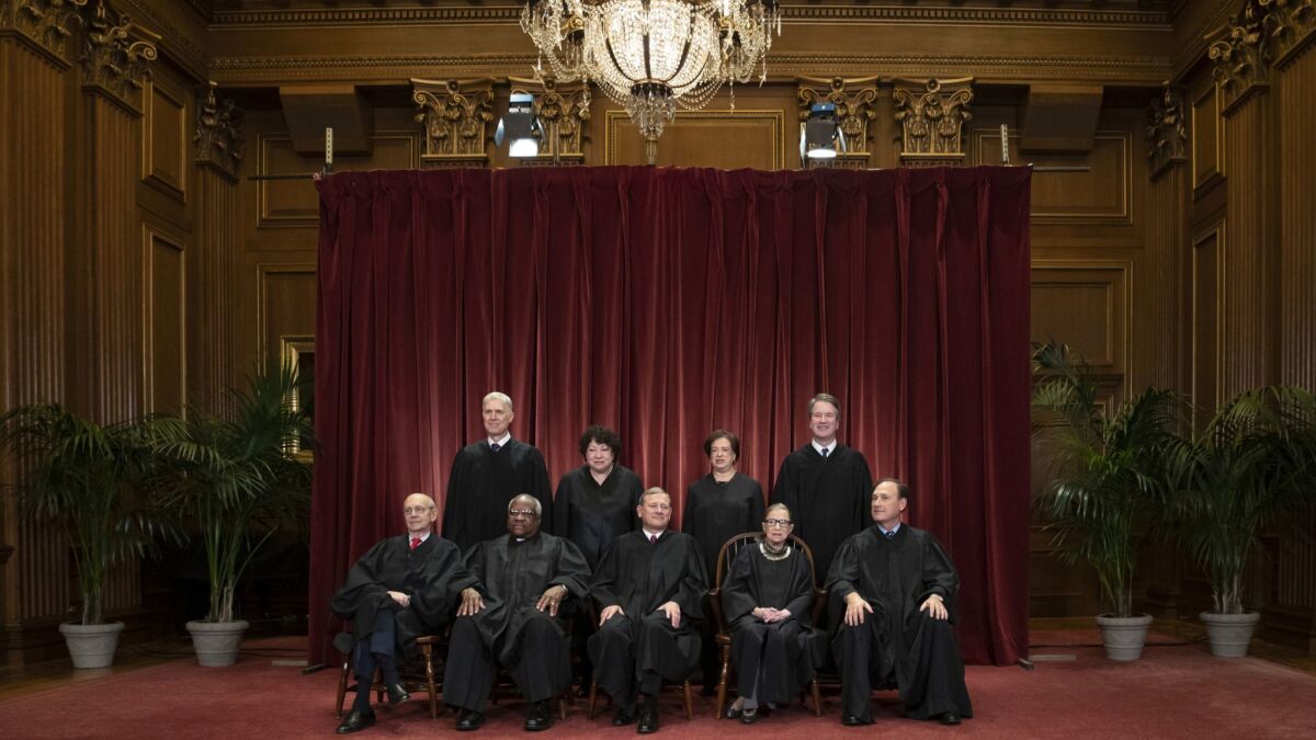 The Supreme Court justices gather for a formal group portrait at the Supreme Court Building in Washington on Nov. 30, 2018.