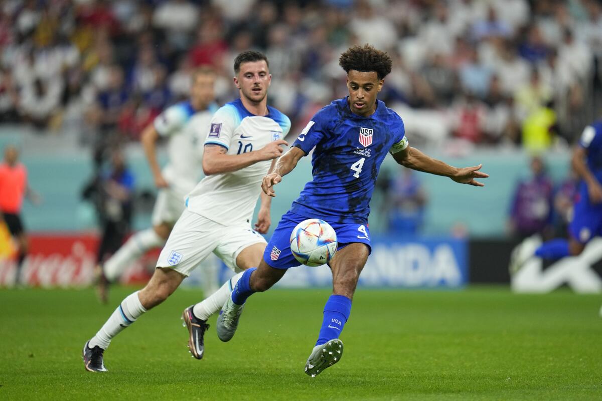U.S. midfielder Tyler Adams, right, controls the ball in front of England midfielder Mason Mount.
