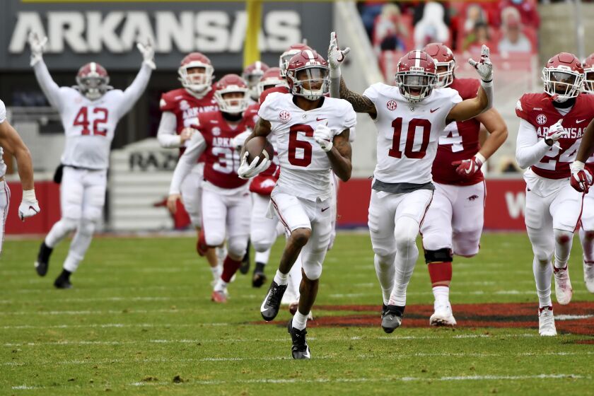 Alabama's DeVonta Smith (6) returns a punt for a touchdown against Arkansas during the first half of an NCAA college football game Saturday, Dec. 12, 2020, in Fayetteville, Ark. DeVonta Smith is The Associated Press college football player of the year, becoming the first wide receiver to win the award since it was established in 1998, Tuesday, Dec. 29, 2020.(AP Photo/Michael Woods)
