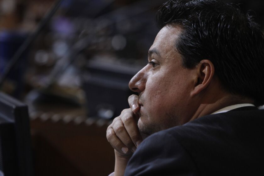 Los Angeles Councilman Jose Huizar, shown at a February meeting, was not in the room when the City Council voted on the lawsuit.