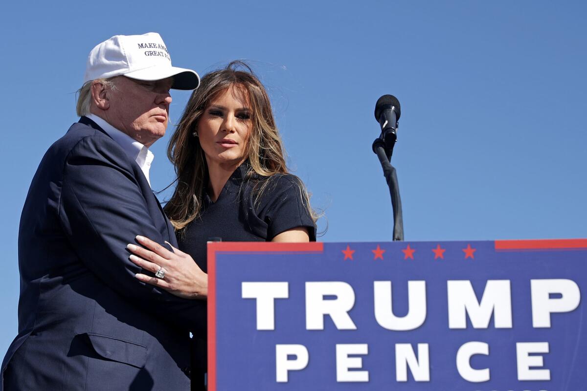 Donald and Melania Trump arrive for a campaign rally at Wilmington International Airport