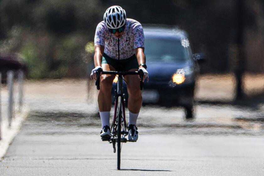 Pasadena, CA, Wednesday, September 4, 2024 -Heat waves rise from the hot pavement as a biker travels along Arroyo Seco outside the Rose Bowl as temperatures hit the mid 90's. (Robert Gauthier/Los Angeles Times)