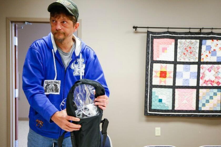Danny Fouts, of Topmost, Ky., a former coal miner living with black lung disease packs his portable oxygen machine before a protest near the office of Senate Majority Leader Mitch McConnell at the Laurel County Justice Center in London, Ky., Wednesday, Dec. 19, 2018. Fouts was diagnosed with black lung in 2004 after working as a coal miner for 24 years. He uses inhalers such as Albuterol, Spiriva and Symbicort in addition to oxygen to aid his breathing.