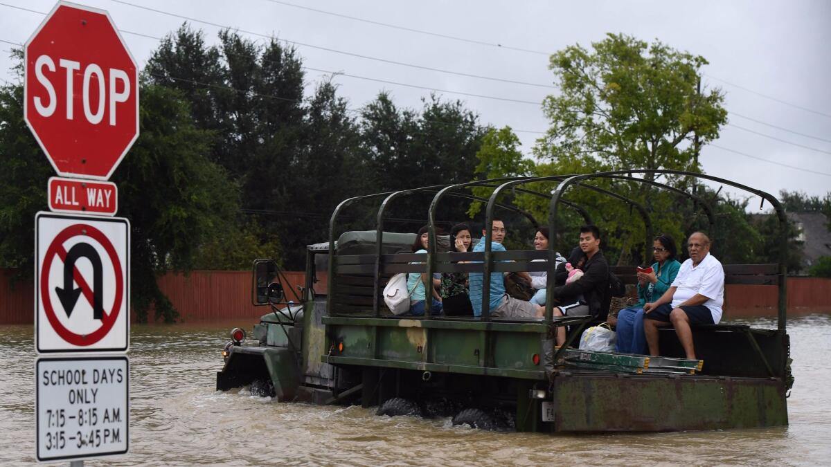 Residents are evacuated by a military vehicle in the Clodine district after Hurricane Harvey caused heavy flooding in Houston.