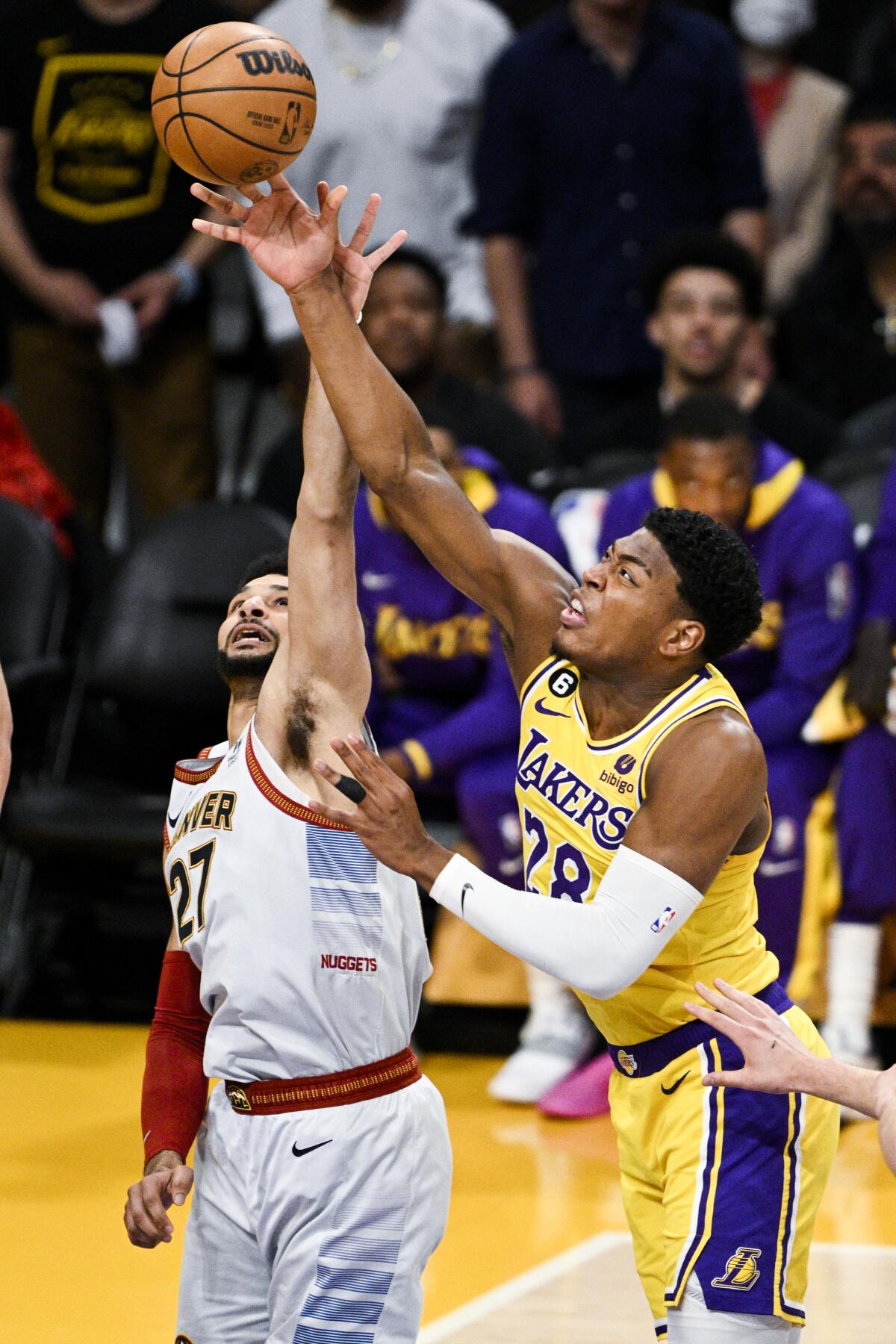 Lakers forward Rui Hachimura, right, goes up for a shot while defended by Nuggets guard Jamal Murray.