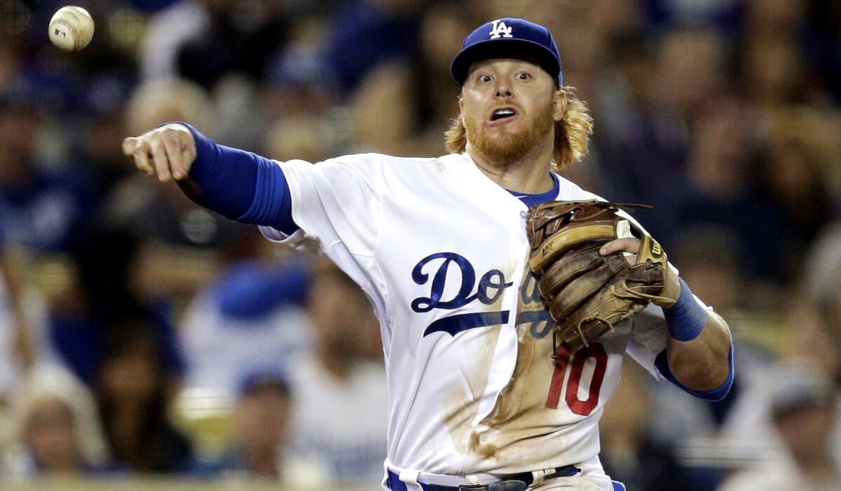 Dodgers third baseman Justin Turner throws to first base to put out Cincinnati's Todd Frazier during the seventh inning of a game earlier this season at Dodger Stadium.