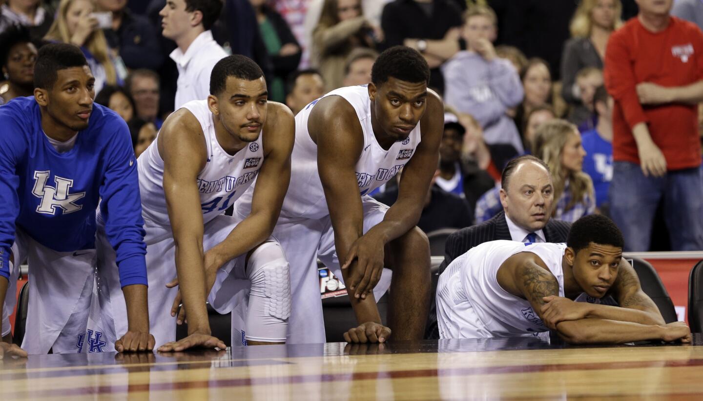 Kentucky players watch from the bench as Wisconsin clings to a lead late in the Final Four game.