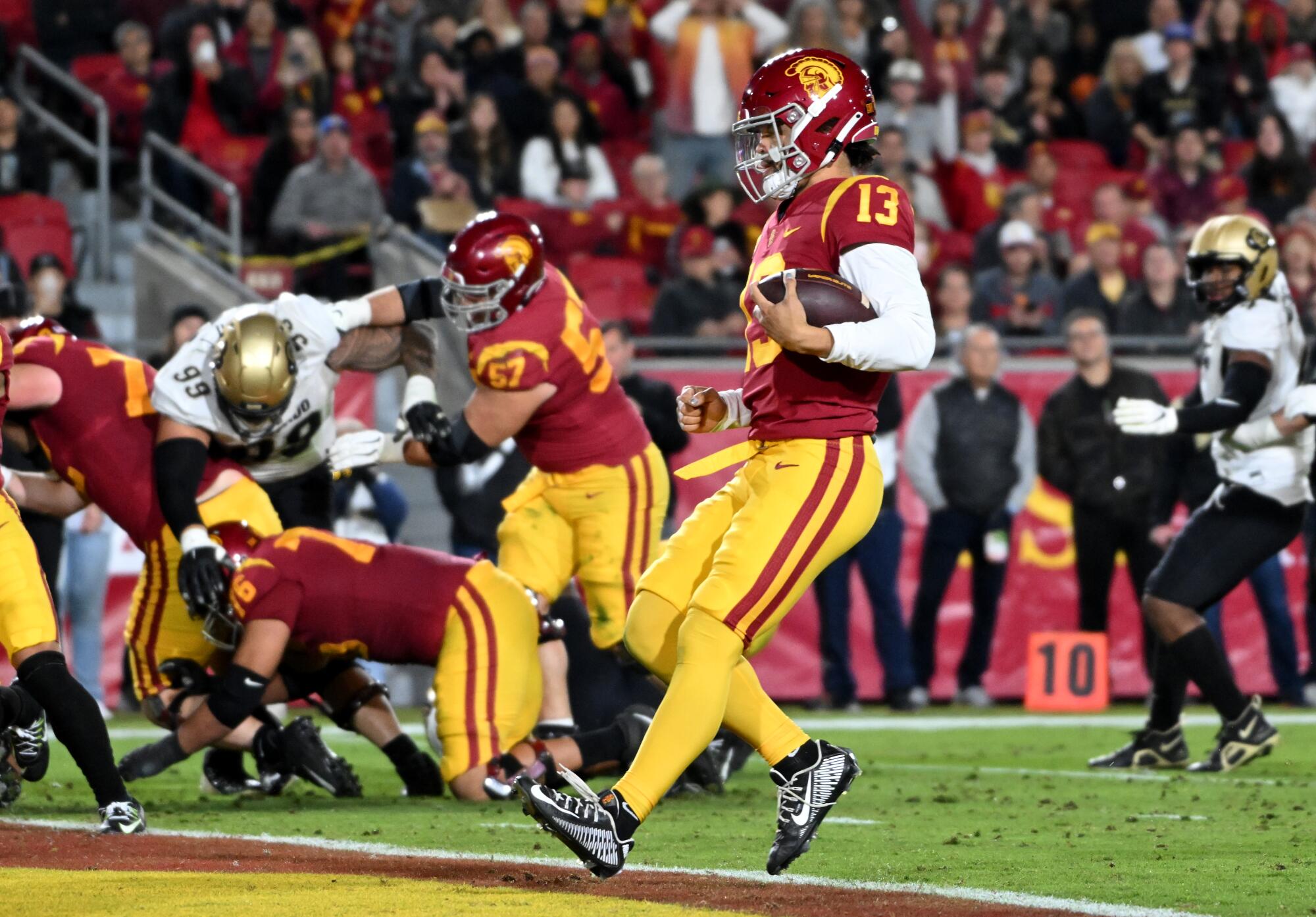 USC quarterback Caleb Williams scrambles into the end zone to score a touchdown against Colorado in the second quarter.