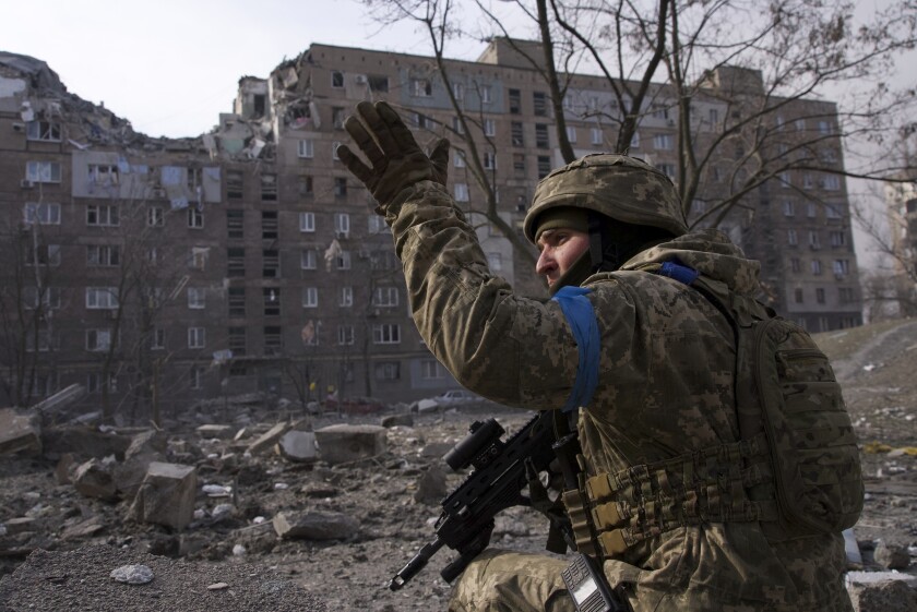 A Ukrainian military man guards his position in Mariupol, Ukraine.