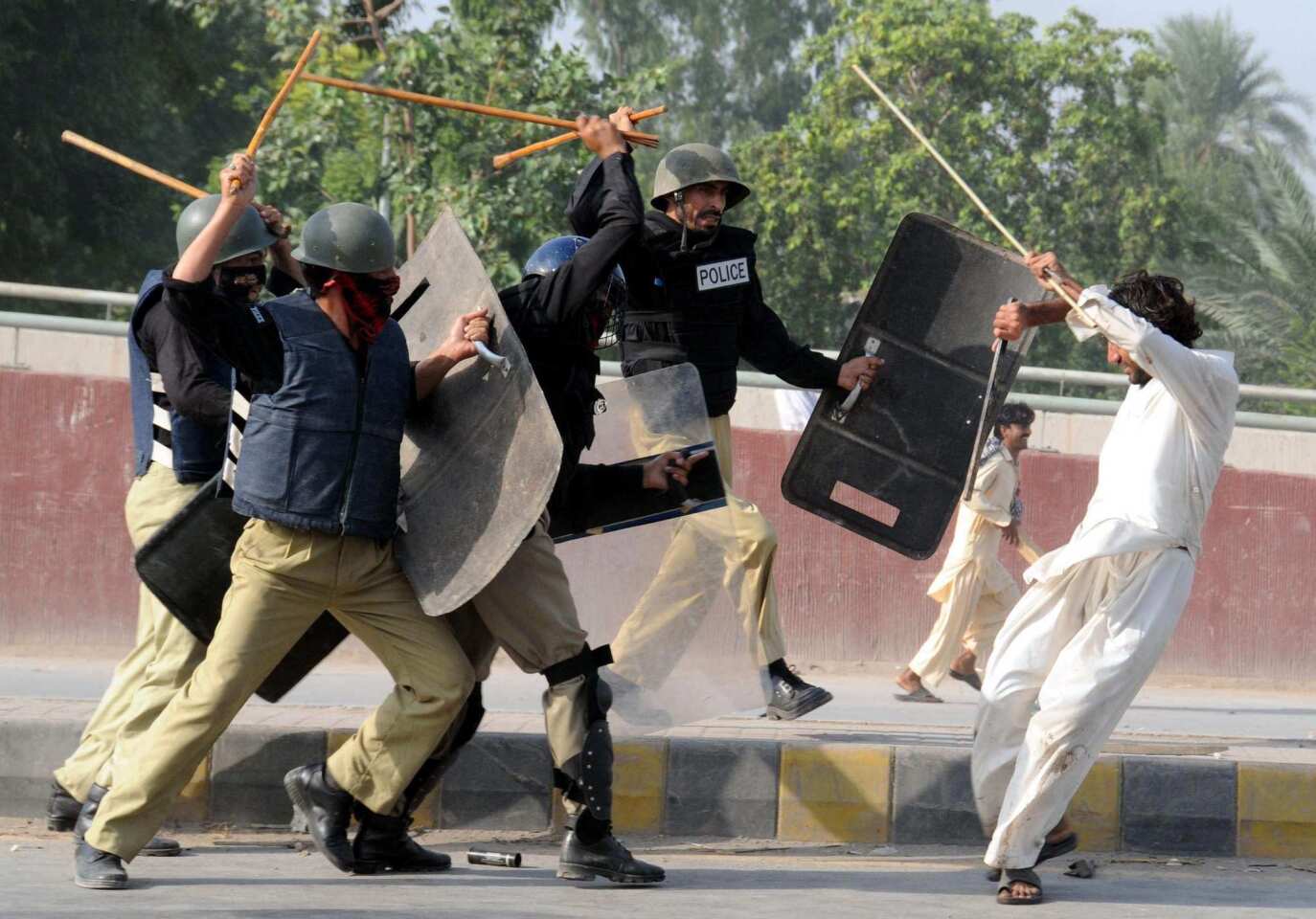 Riot police in Peshawar descend upon protesters with batons during a demonstration protesting the anti-Islam movie "Innocence of Muslims." Violence erupted across Pakistan on Friday amid anger over the film.