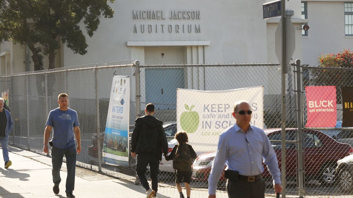 Parents walk past the Michael Jackson Auditorium on Tuesday as they drop off children at Gardner Street Elementary in Hollywood.