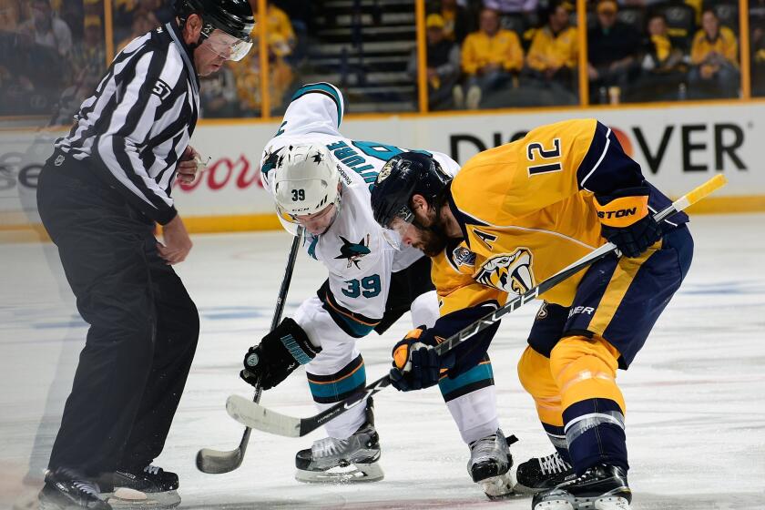 San Jose's Logan Couture (39) takes a faceoff against Nashville's Mike Fisher on May 9.