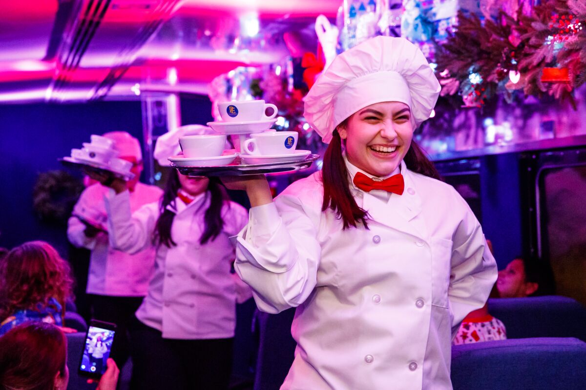 Dancing servers break out the hot chocolate aboard the Polar Express Train Ride.