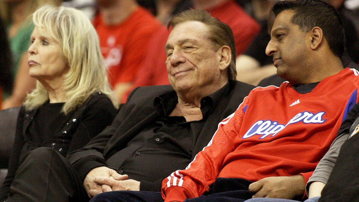 Clippers owner Donald Sterling, center, sits next to his wife, Rochelle, left, during a Clippers-Boston Celtics game in 2011.