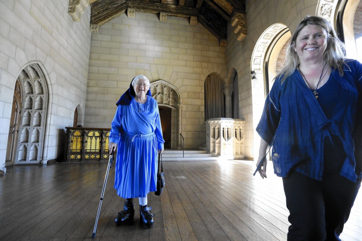 Sister Rita Callanan, 77, left, and restaurateur Dana Hollister walk inside the main room of a villa at the former convent in Los Feliz.