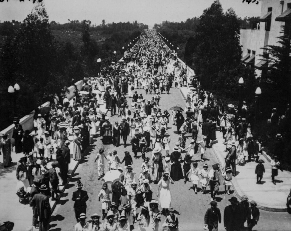 Opening Day, 1915 fair: President Woodrow Wilson signaled the opening of the Panama-California Exposition a few moments after midnight on Jan. 1, 1915, and a few hours later the Cabrillo Bridge was filled with well-dressed first-day attendees, young and old. The adult admission was 50 cents (25 cents evenings and Sundays) and the annual pass cost $10; an extra 25 cents was charged if you carried a camera. The 640 acres of the Central Mesa were lushly landscaped and the buildings – most intended as only temporary installations – presented a Spanish Colonial revival look, a departure from the traditional Greek and Roman classic look of earlier expos. By year's end, attendance reached 2 million and the fair produced a surplus of $34,000. San Francisco's Panama-Pacific International Exposition attracted nearly 19 million and produced a $2.4 million surplus over the same period. The San Diego fair was so popular that civic leaders moved to extend it a second year -- and to incorporate some of the San Francisco exhibits south. – Roger Showley