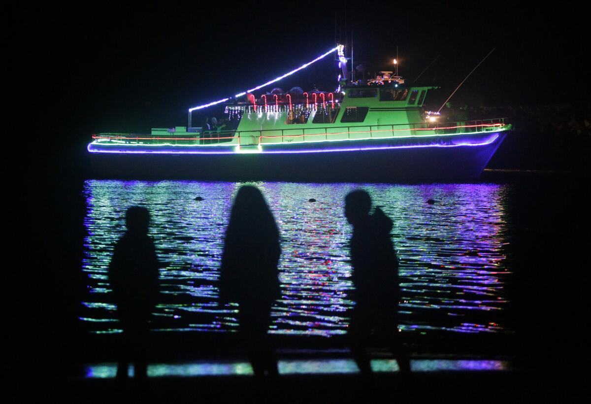 A fishing vessel moves along the route during the 111th Newport Beach Christmas Boat Parade.