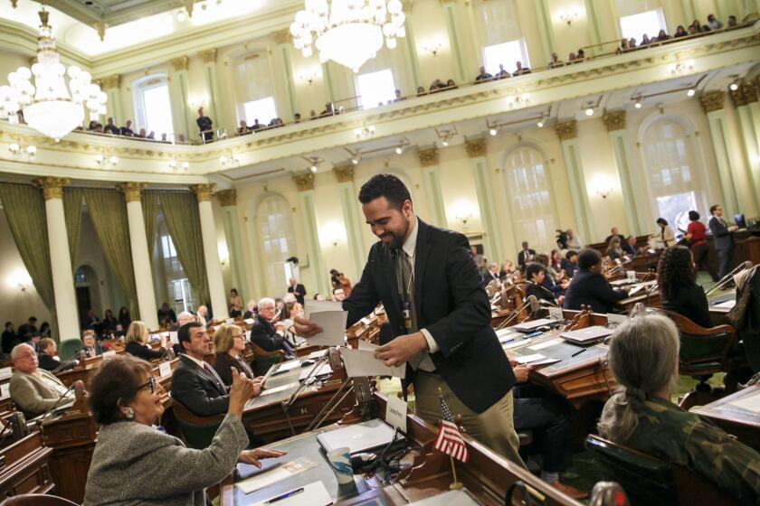 SACRAMENTO, CALIF. -- MONDAY, DECEMBER 19, 2016: Andres Ramos collect the ballots voted by the members of the Electoral College at the State Capitol in Sacramento, Calif., on Dec. 19, 2016. (Marcus Yam / Los Angeles Times)