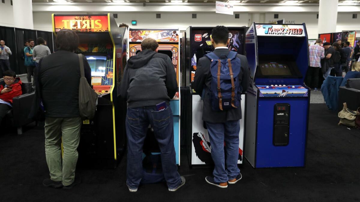 Attendees play vintage video games at the 2019 Game Developers Conference recently in San Francisco.