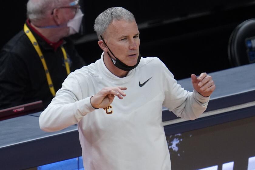 USC coach Andy Enfield watches play against Drake during the second half March 20, 2021.