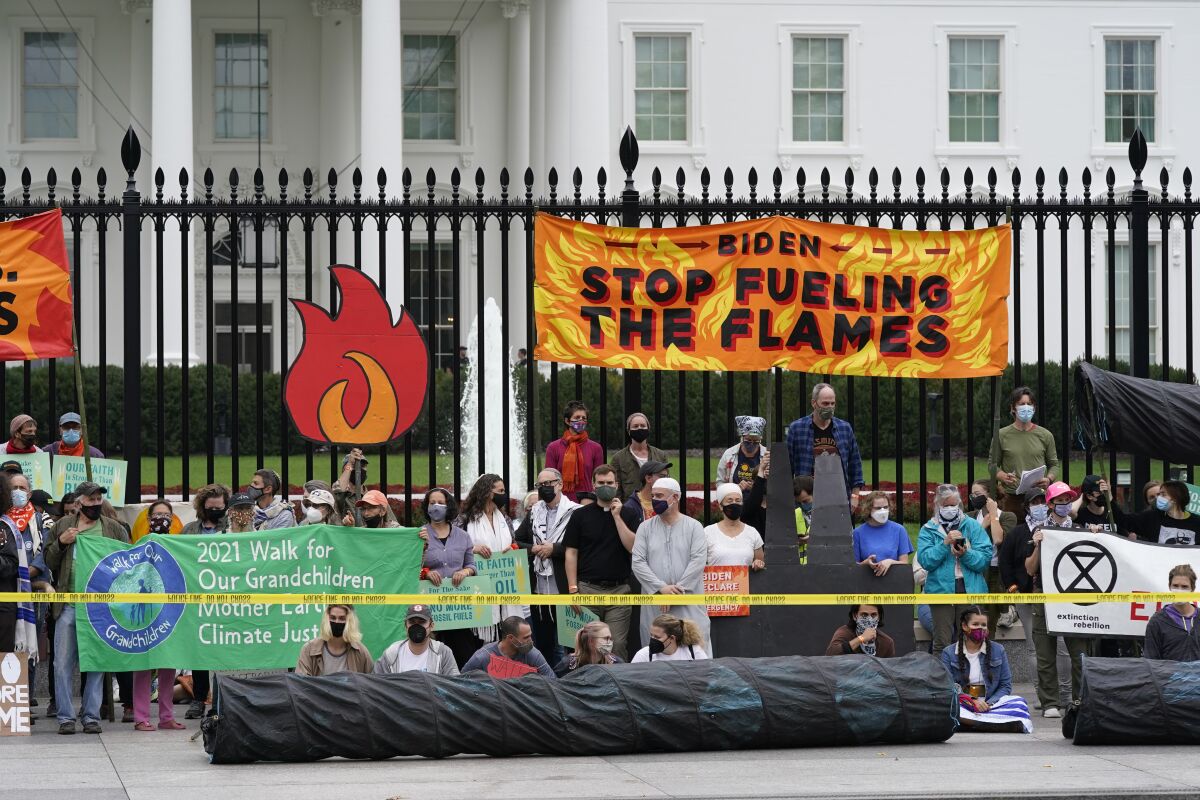 Protesters gather to call on the Biden administration to do more to combat climate change and ban fossil fuels outside the White House in Washington, Tuesday, Oct. 12, 2021. (AP Photo/Patrick Semansky)