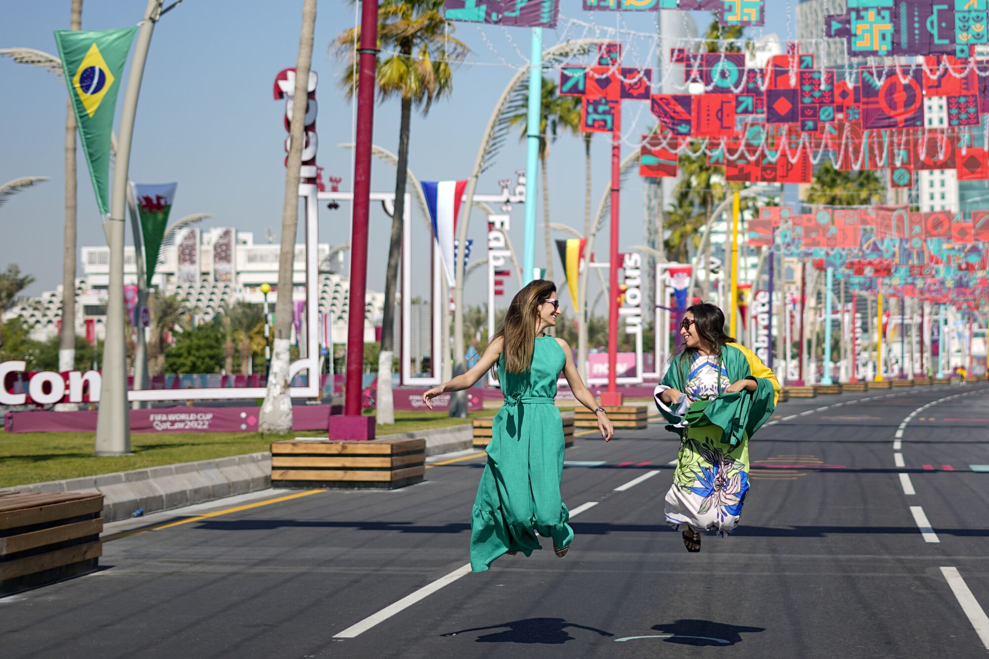 Brazil fans jump for a photo along the Doha Corniche in Qatar on Wednesday.