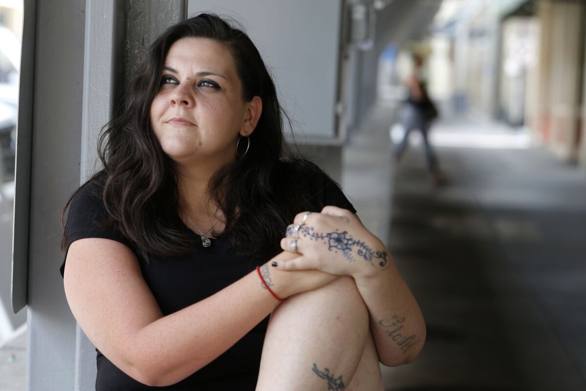 Former Fluvanna Correctional Center for Women inmate Stephanie Parris sits in Market Square on Wednesday, July 15, 2020, in Roanoke, Va. Parris was finishing a two-year prison sentence for a probation violation when she heard she’d be going home three weeks early because of COVID-19. (AP Photo/Steve Helber)