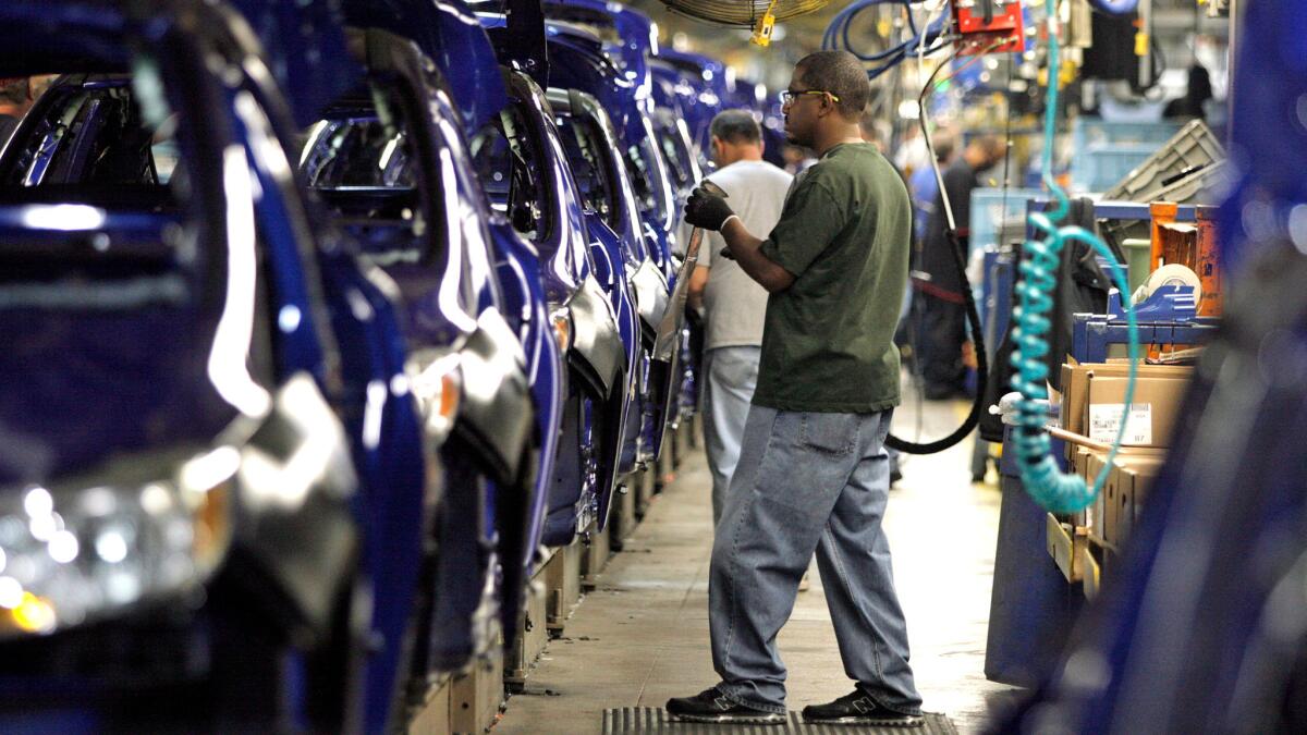 Workers build the Ford Focus at an assembly line in Wayne, Mich., in 2011. Ford is moving production of all its small cars to Mexico.