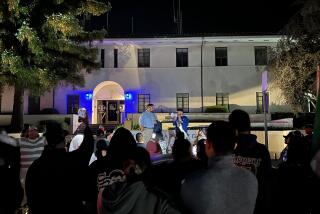 Activist Edin Alex Enamorado and Santa Barbara City Councilmember Oscar Gutierrez speak on the steps of the police station