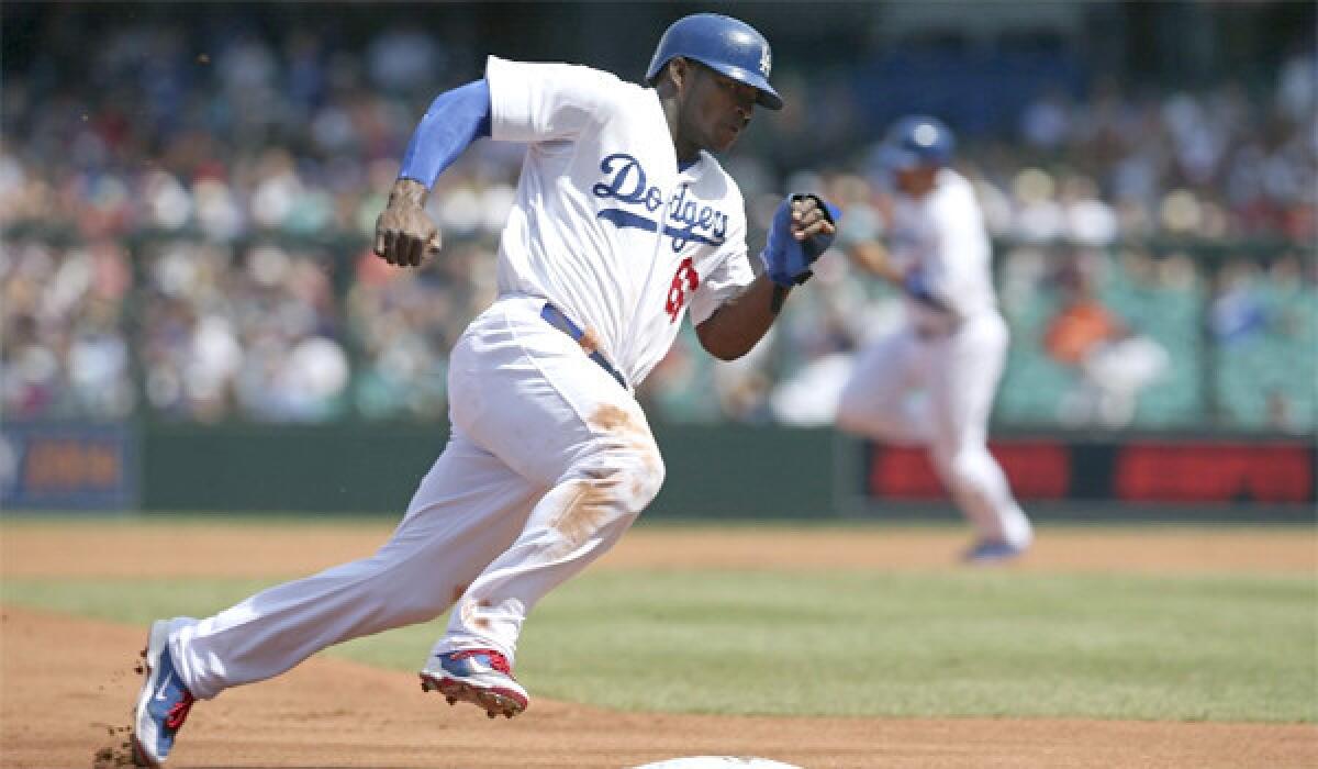 Yasiel Puig rounds third base on his way to score during the Dodgers' 7-5 win over the Diamondbacks in the second game of their two-game series in Australia with Arizona.