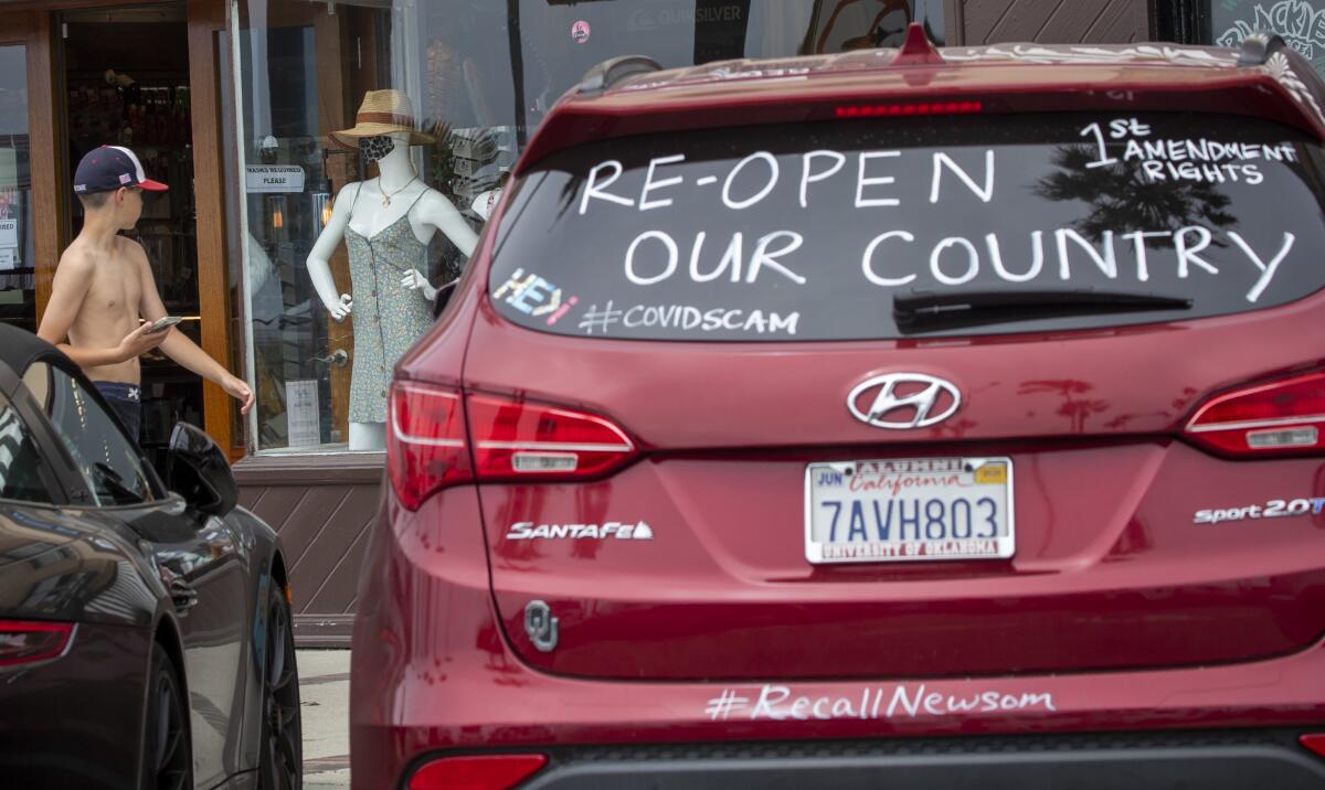 A motorist makes a statement via a car window in Newport Beach.