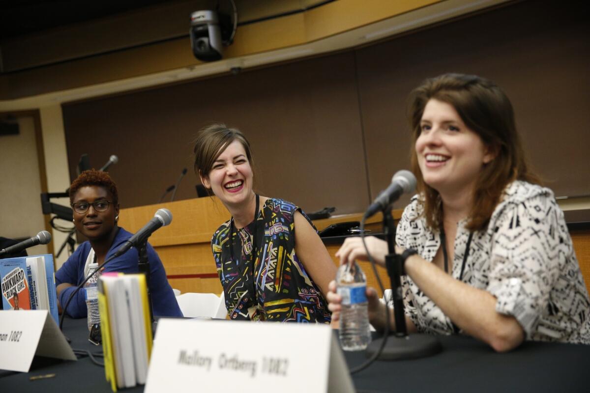 Moderator Ann Friedman and panelist Issa Rae smile while listening to Mallory Ortberg speak on the "Writing With a Smirk: Women and Humor" panel during the 20th Los Angeles Times Festival of Books at USC.
