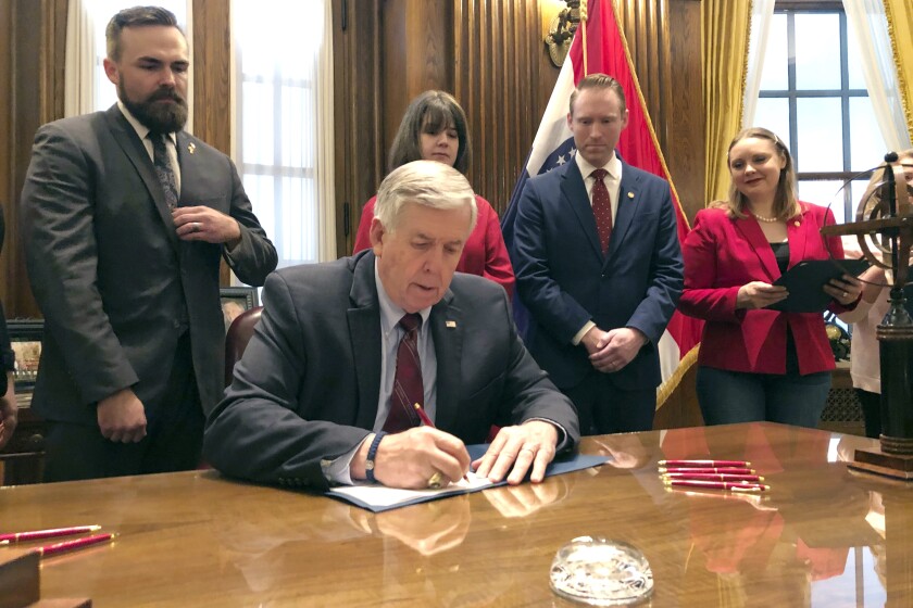 FILE- In a May 24, 2019, file photo, Missouri Gov. Mike Parson signs one of the nation's most restrictive abortion bills, banning the procedure on or beyond eight weeks of pregnancy, in Jefferson City, Mo. A federal appeals court panel on Wednesday, June 9, 2021, blocked Missouri from enforcing the sweeping state abortion law. A three-judge panel of the 8th U.S. Circuit Court of Appeals in St. Louis heard arguments in September in the legal battle over the 2019 law. (AP Photo/Summer Balentine, File)