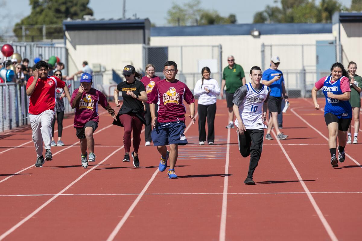 Participants from different high schools participate in the 50 meter dash on Thursday.