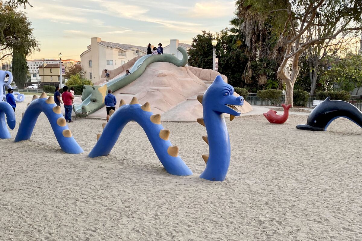 A blue concrete sea serpent undulates in the sand at La Laguna de San Gabriel.