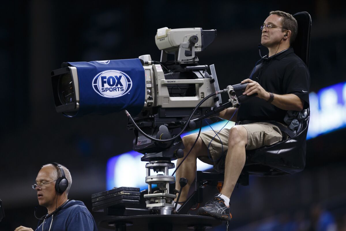 Fox Sports camera crew is seen during an NFL football game in Detroit last year.