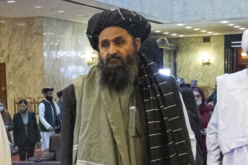 FILE - In this March 18, 2021, file photo, Taliban co-founder Mullah Abdul Ghani Baradar, arrives with other members of the Taliban delegation for an international peace conference in Moscow, Russia. Baradar's biography charts the Taliban's long journey from a pious but brutal Islamic militia to an insurgency that battled the U.S. for two decades, ultimately returning to power through pragmatic diplomacy and military might. His experience also sheds light on the Taliban's complicated relationship with neighboring Pakistan. (AP Photo/Alexander Zemlianichenko, Pool, File)