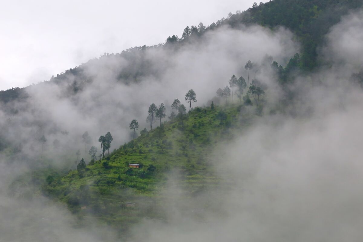 Monsoon mist hangs over the foothills outside Adhikarichaur, Nepal.