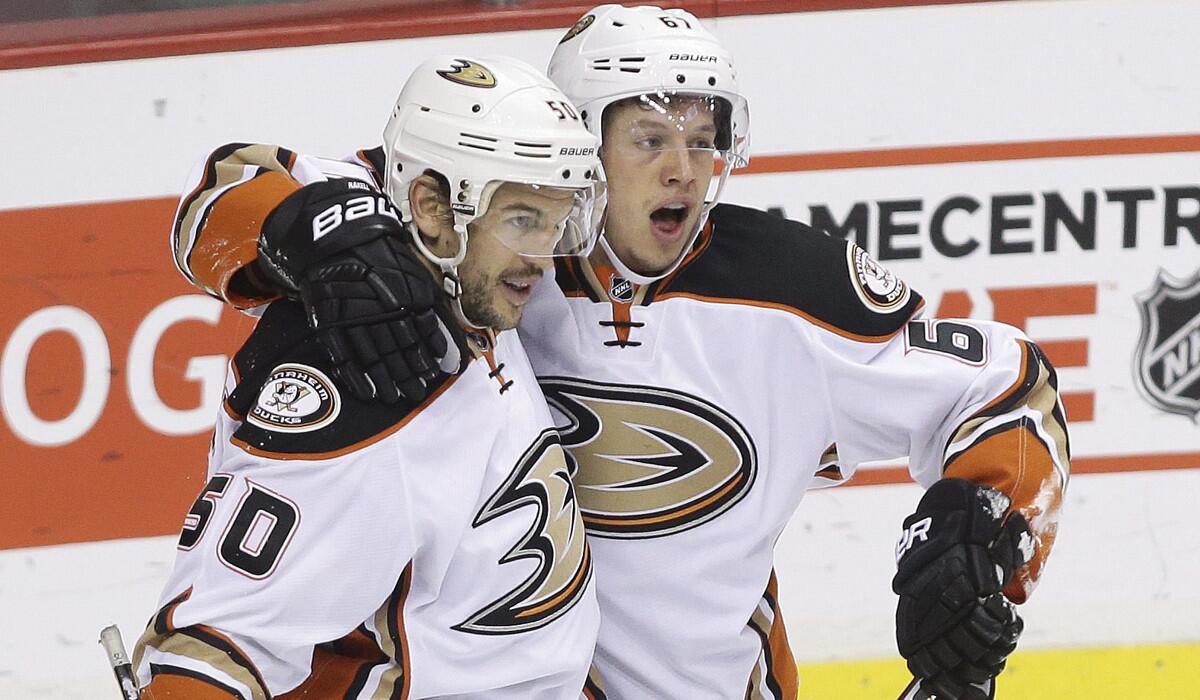 Antoine Vermette, left, Rickard Rakell, right, and the rest of the Ducks received some strongly worded instructions from Coach Randy Carlyle during practice.