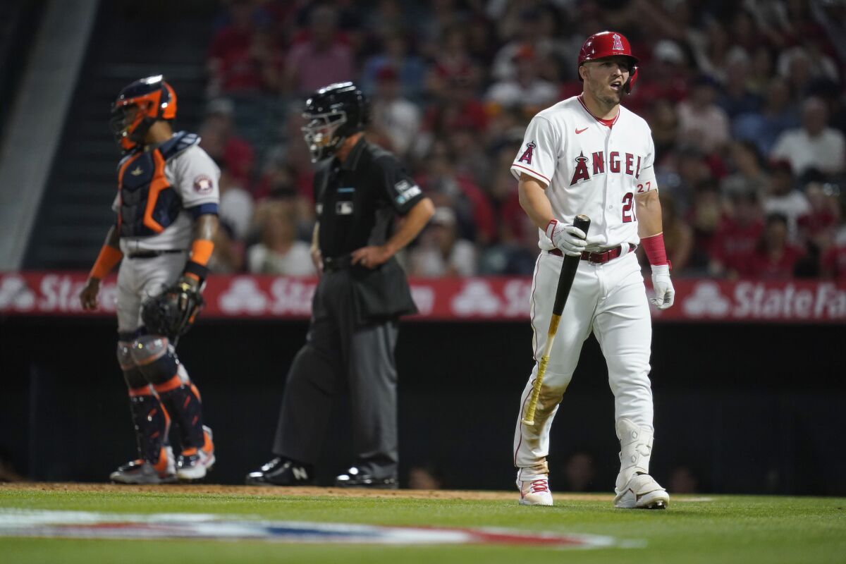 Angels' Mike Trout walks back to the dugout after striking out.
