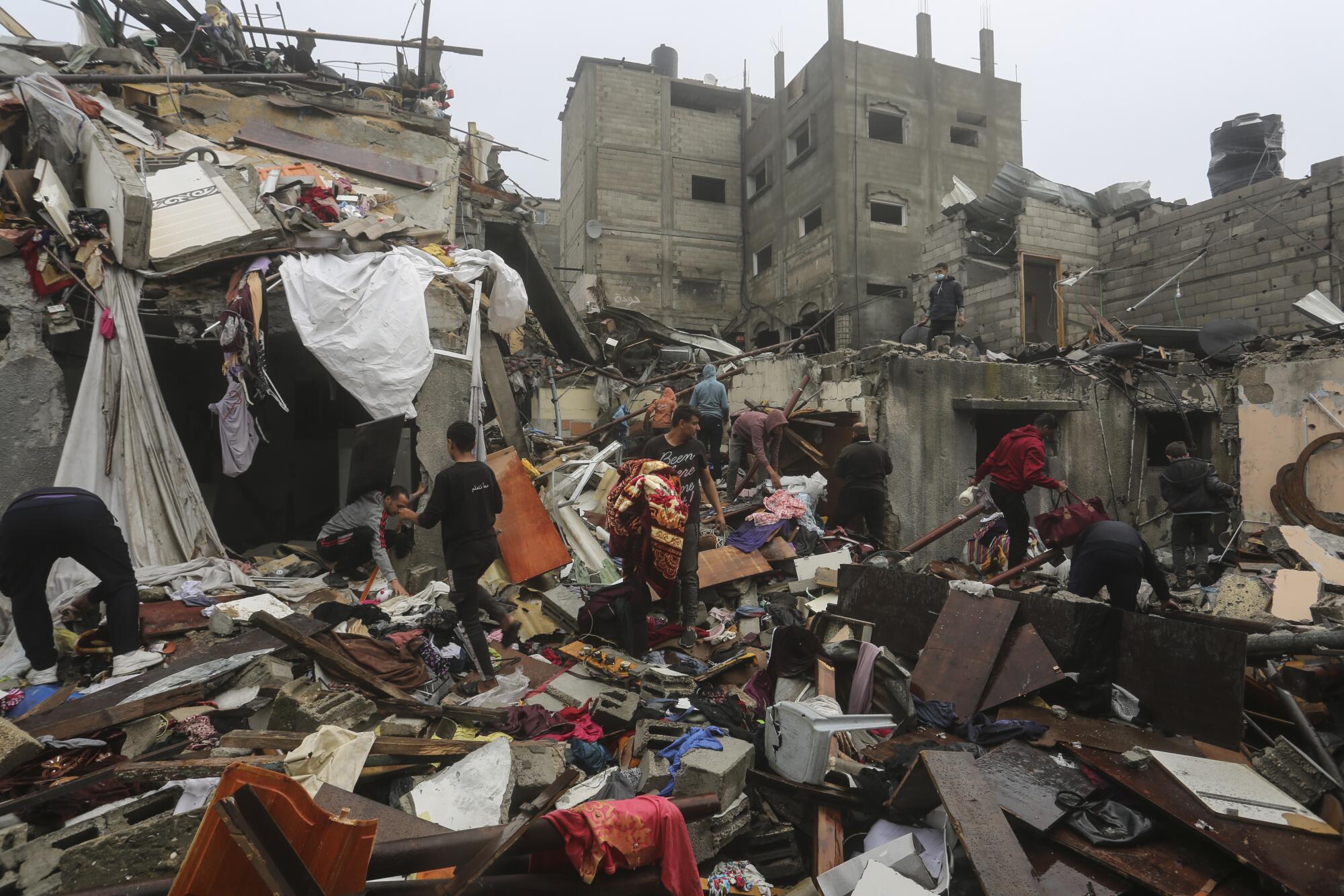Gazans salvaging their belongings after an Israeli airstrike on Rafah
