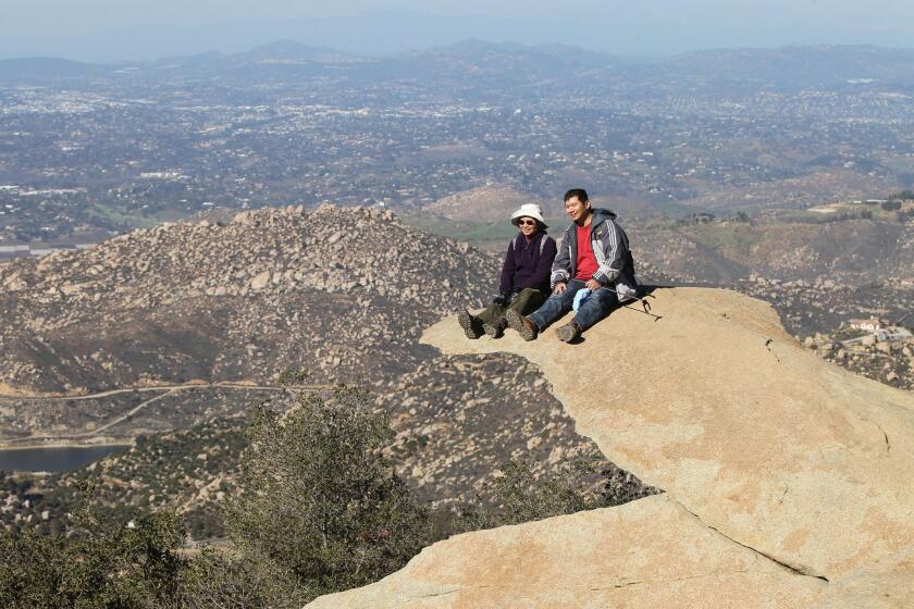 Susan Chen, left, here visiting from Quam, sits with her son Jusuan Lee, of San Diego on popular "Potato Chip Rock," high on top of Mt. Woodson.