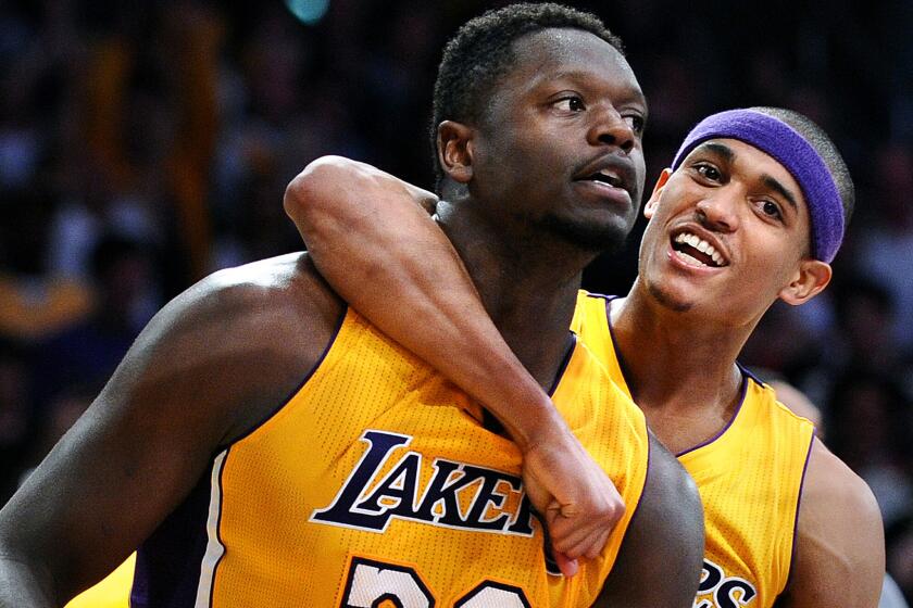 Lakers forward Julius Randle is hugged by Jordan Clarkson after making the go-ahead basket against the Miami Heat late in a 102-100 victory on March 30.